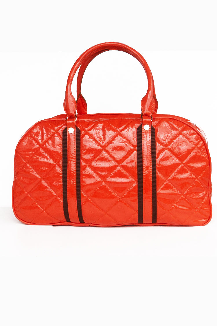 Travel bag in patent leather, padded